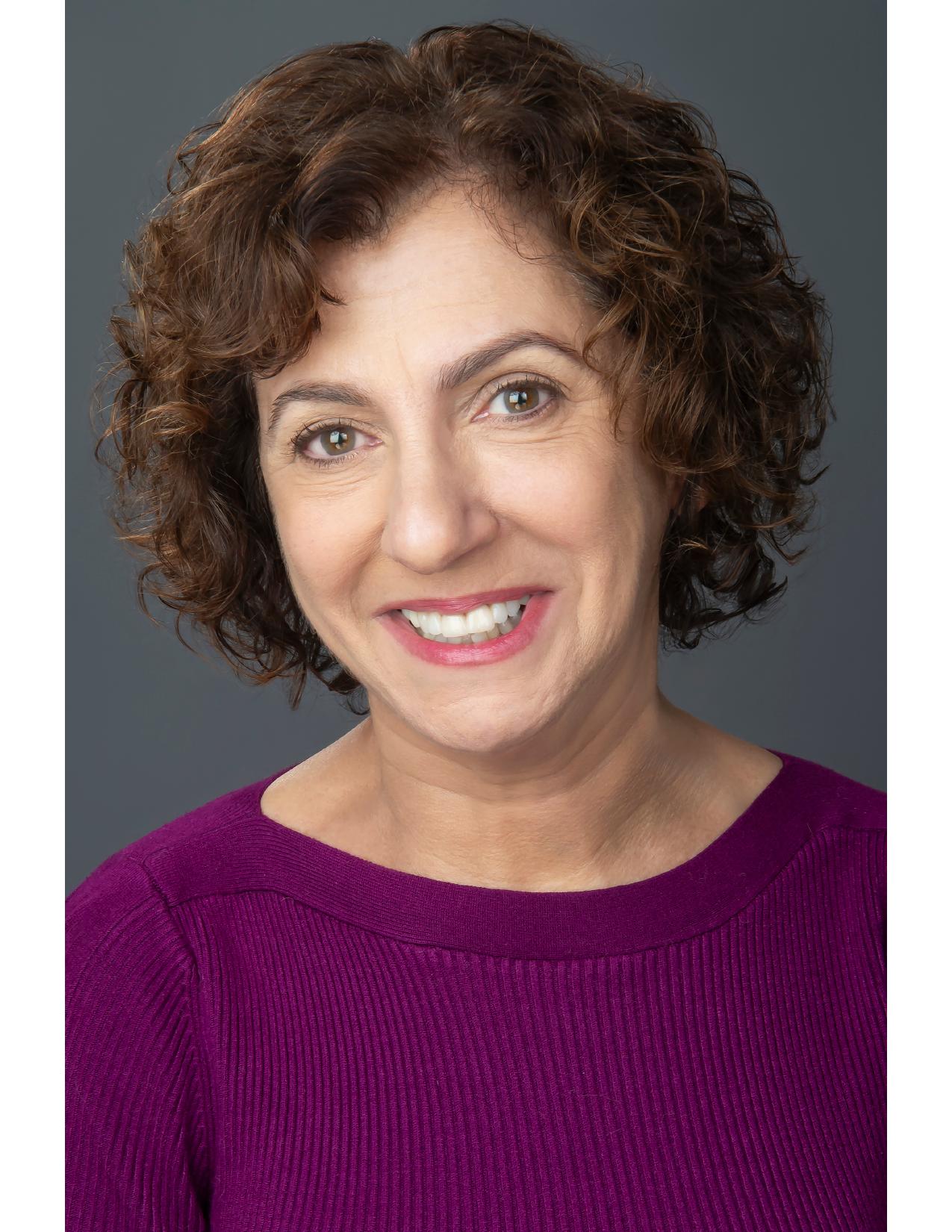 Nancy Levine headshot in a purple sweater